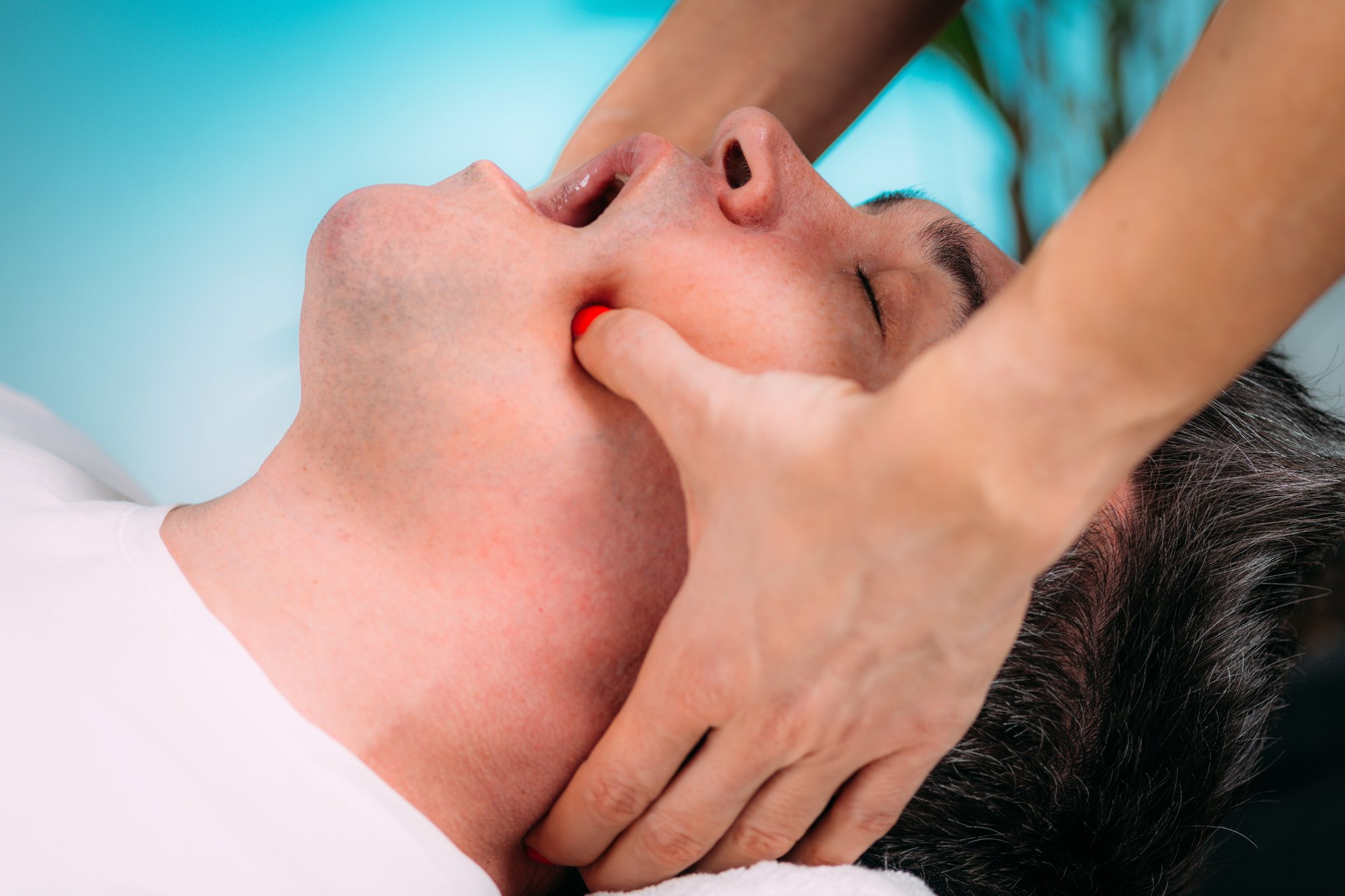 jaw-massage-therapist-doing-realignment-massage-2024-10-18-09-11-27-utc